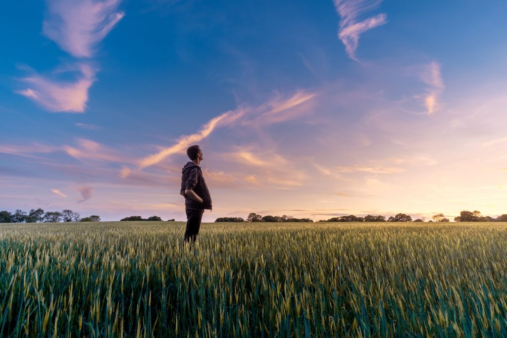 a guy standing in a field